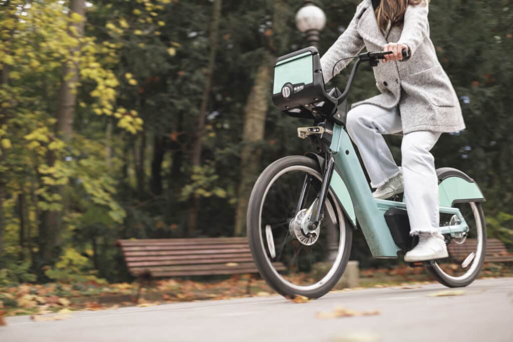 Closeup of woman riding an e-bike at high speed.