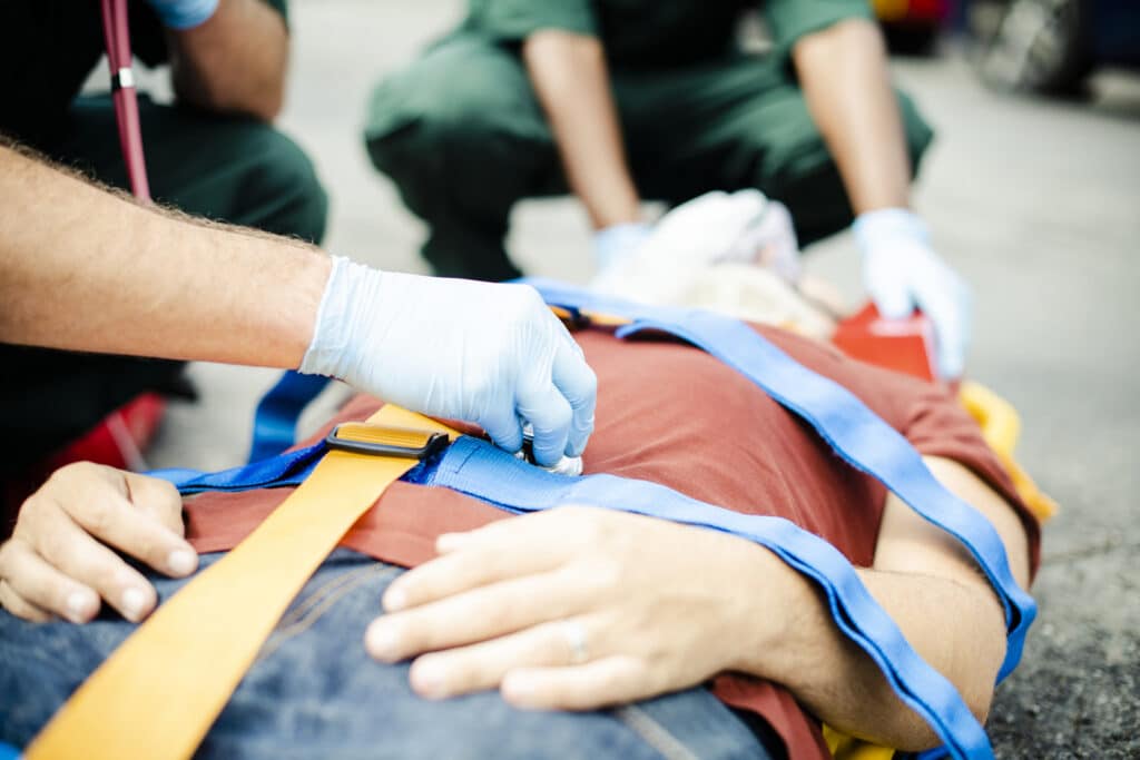 Paramedic team rescuing a critical patient after a car accident